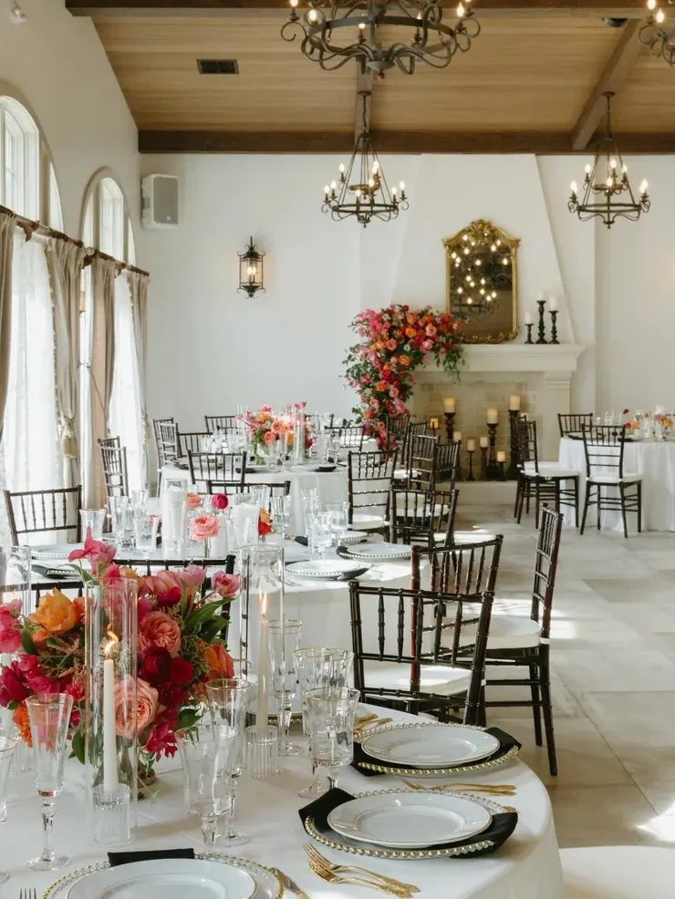 Reception tables set with candles and coral florals at 9 Aviles in historic St. Augustine