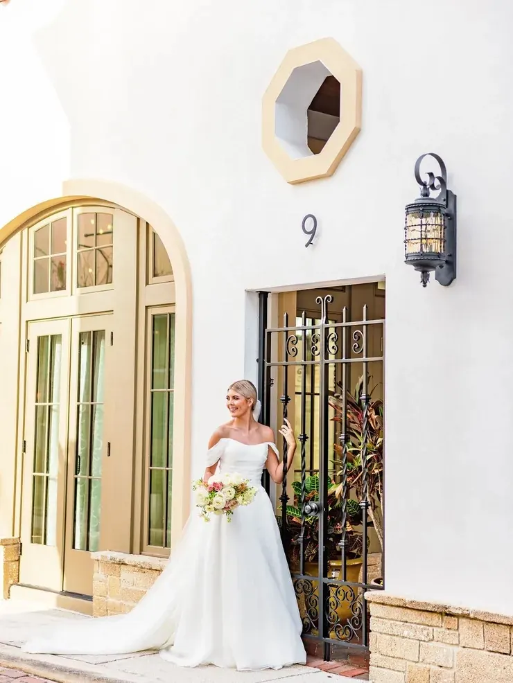 Bride at the arched front entrance of 9 Aviles Street wedding venue in St. Augustine
