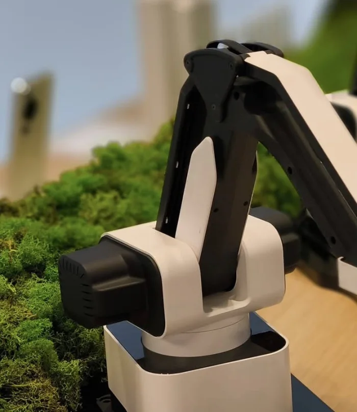 A robotic plotter arm of the kind used at the Extreme Mobile Entertainment AI sketch portrait station