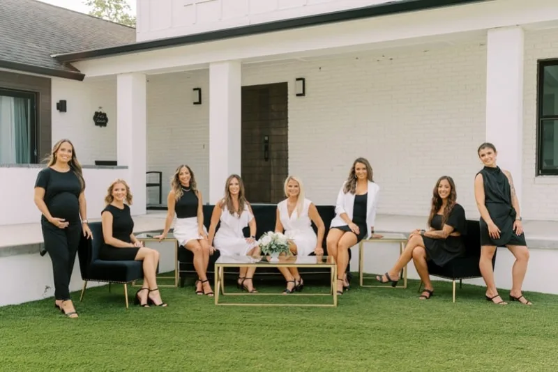 The Coastal Celebrations wedding planning team of eight, photographed outdoors in St. Augustine, Florida
