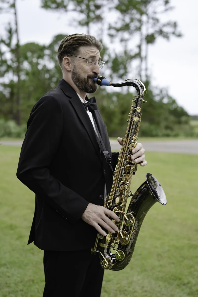 Corey Peterson performing live saxophone at Hammock Beach wedding ceremony