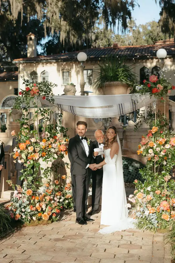 Couple exchanging vows under chuppah at Epping Forest ceremony