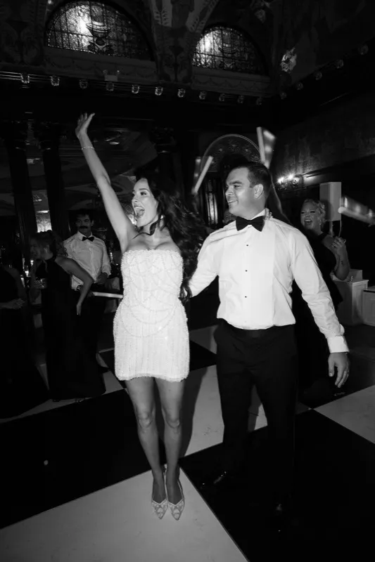 Bride and groom on a packed dance floor at Flagler College Ponce de Leon Dining Hall wedding reception in St. Augustine FL