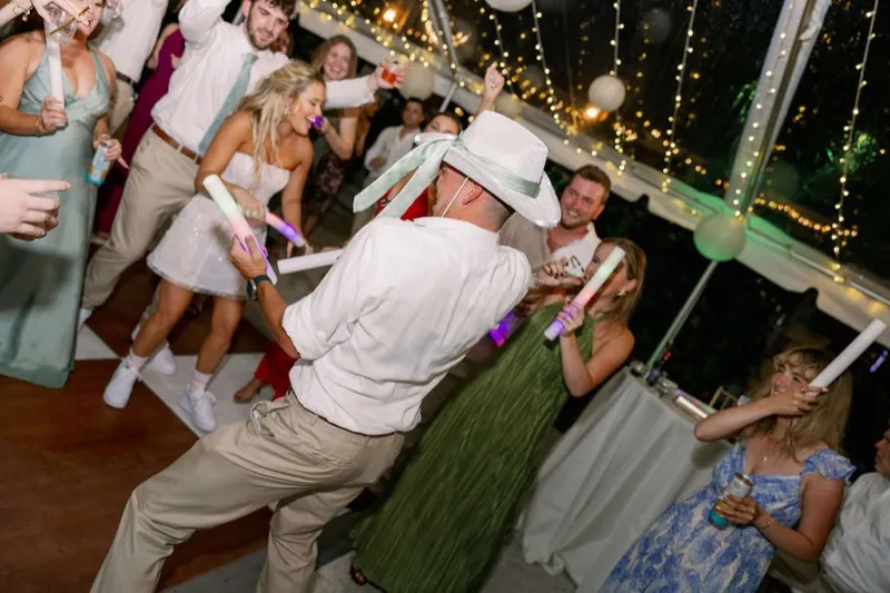 Packed dance floor with glow sticks at Fountain of Youth wedding