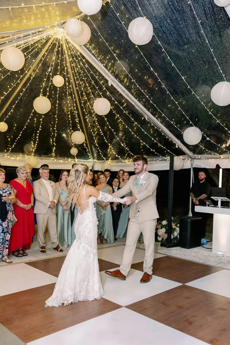 Nicole and Adam first dance at Fountain of Youth wedding with DJ booth and string lights