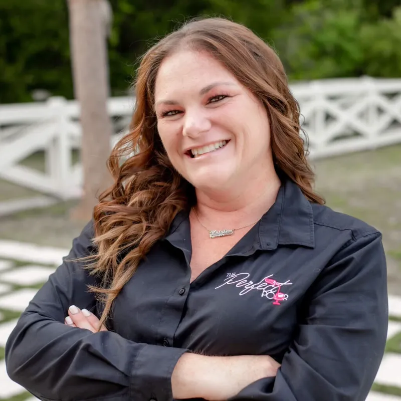Kristen Cumiskey, co-owner of The Perfect Pour, in a branded black shirt