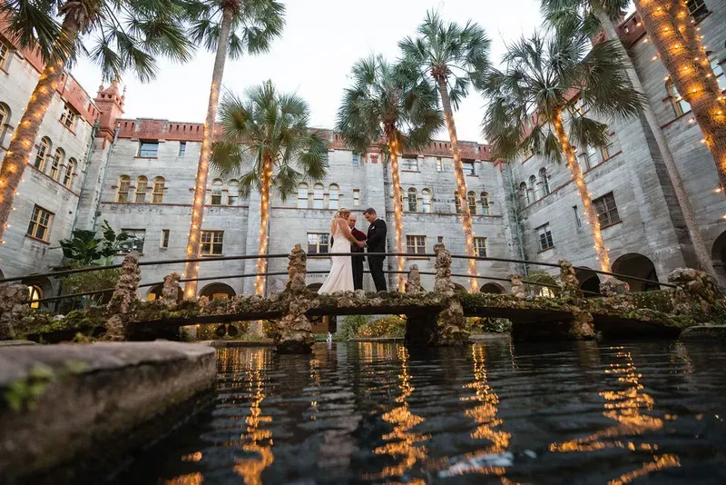 Wedding couple on bridge at Lightner Museum at dusk