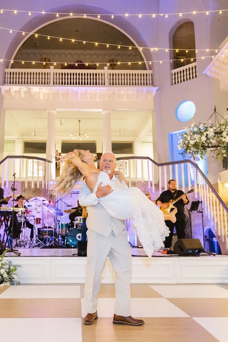 First dance at Lightner Museum with live band Be Easy performing on stage behind the couple