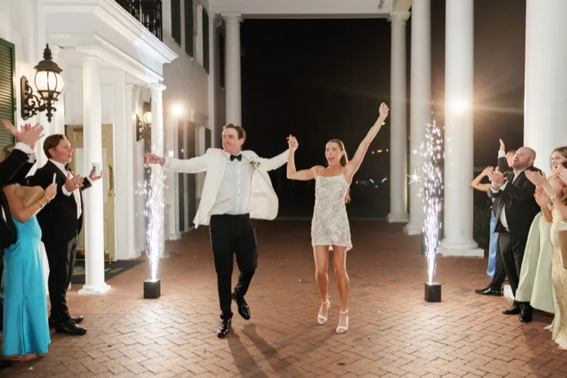 Bride and groom's cold-spark grand exit under the Timuquana Country Club front portico with guests cheering on both sides