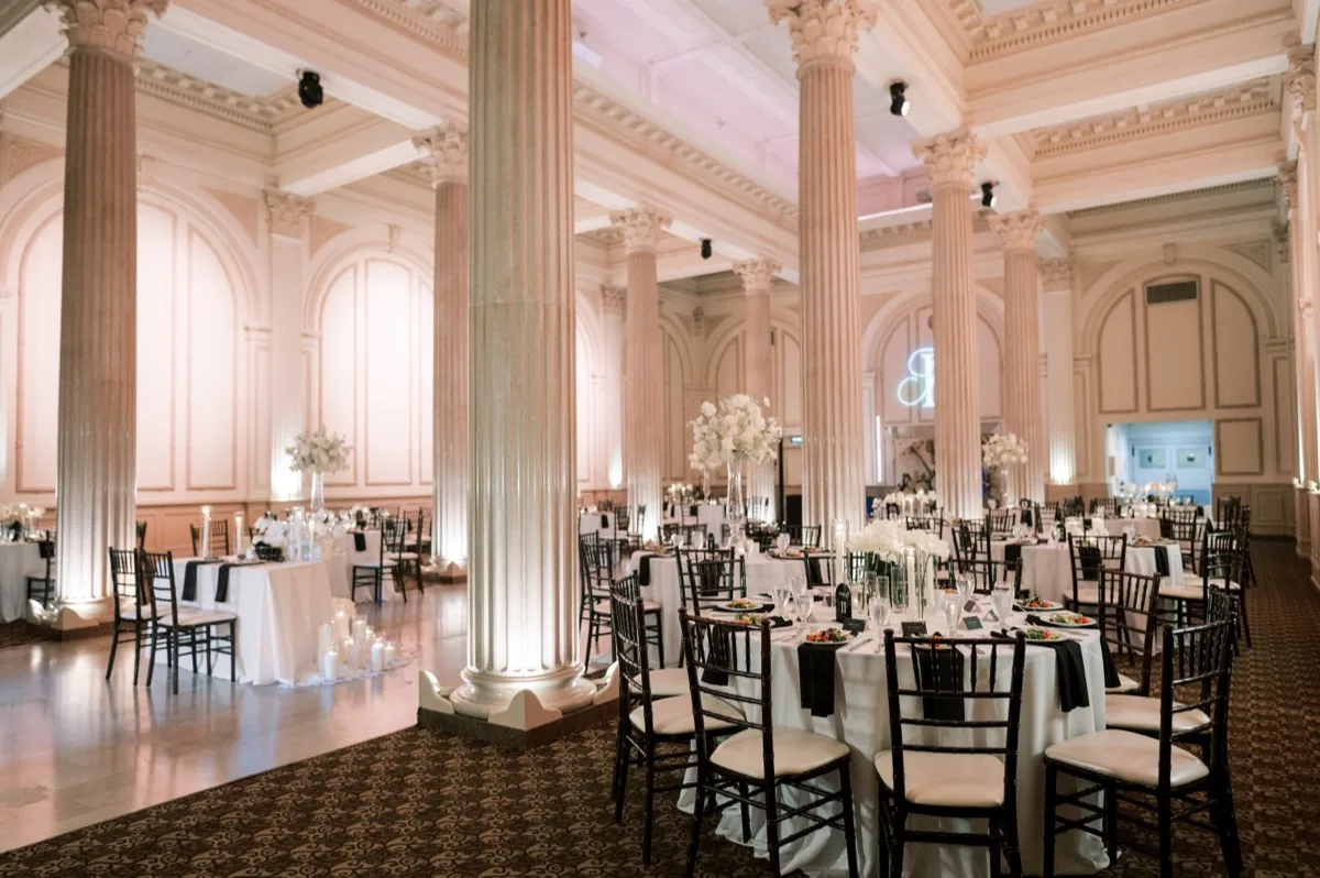 Treasury on the Plaza reception set with candlelit columns and chiavari chairs in St. Augustine